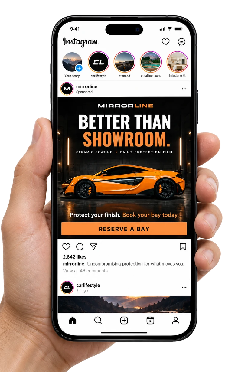 Hand holding a phone showing a sponsored Mirrorline Auto Detailing ad on Instagram